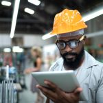 Engineer using tablet and working in factory